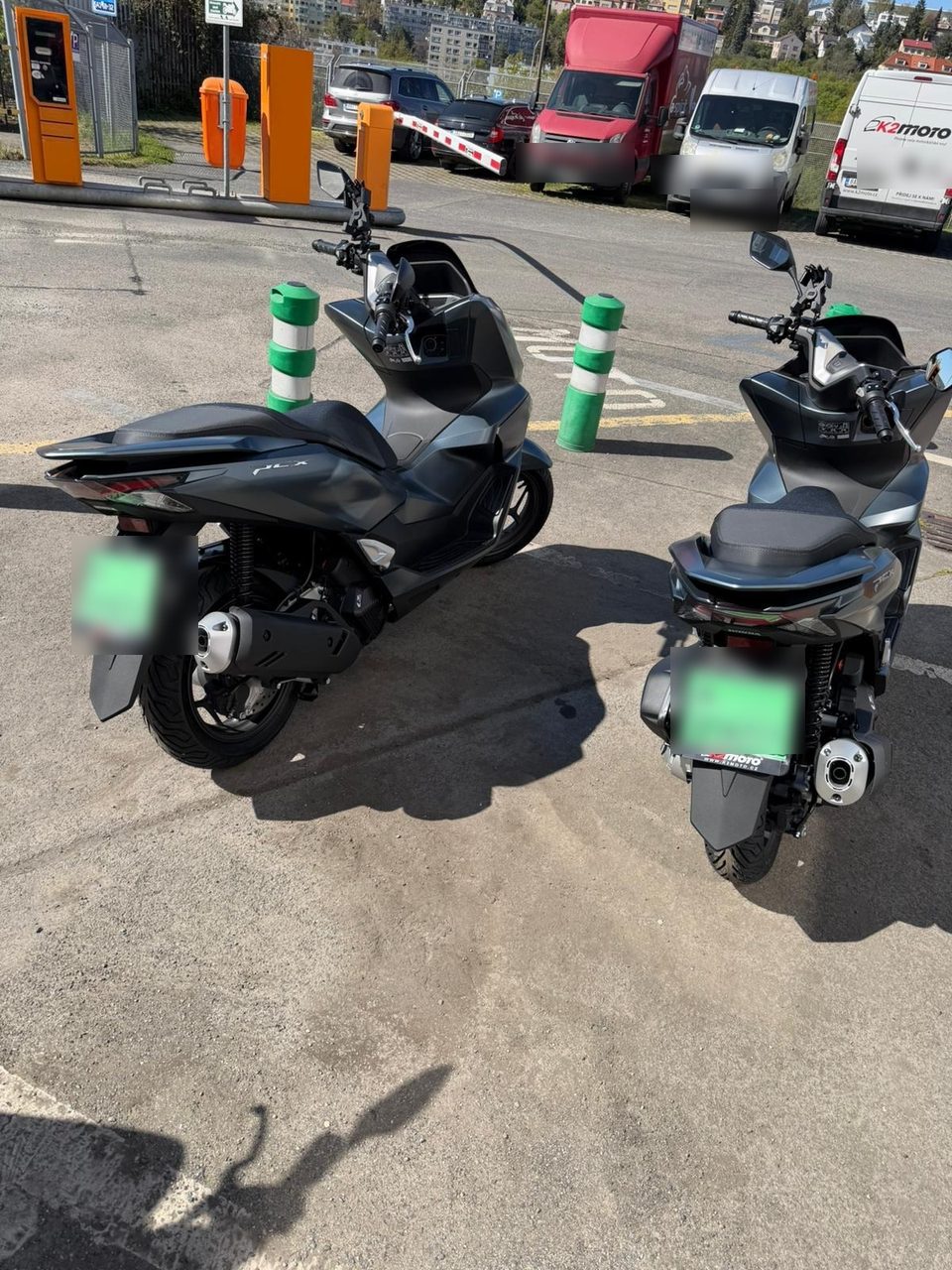 Two Honda PCX scooters of the Svaggy Fleet parked, rear view